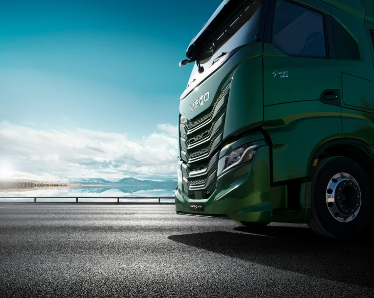 Groene IVECO truck langs kustweg